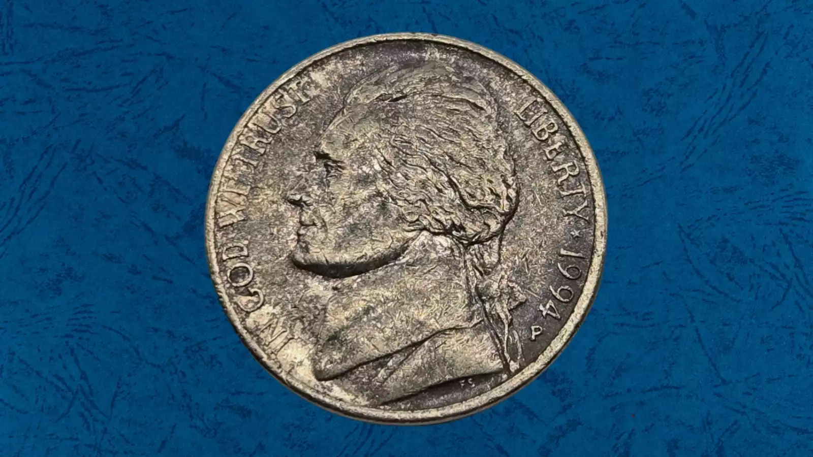 1994 nickel lamination error showing metal layer peeling from Jefferson portrait area